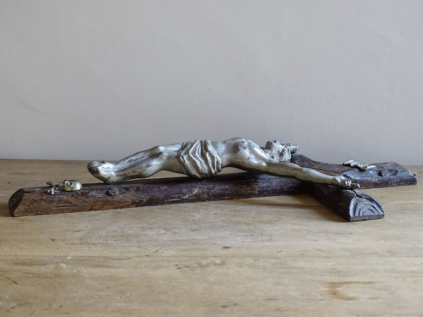 Rustic French faux bois crucifix displayed against pale neutral wall