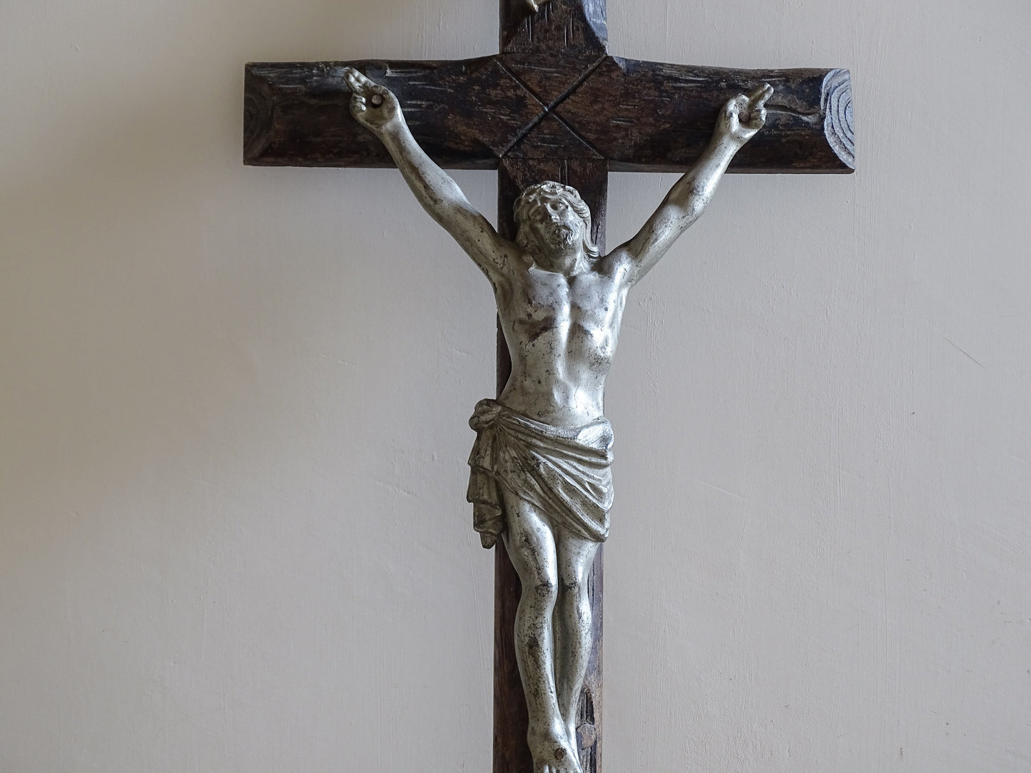 Antique French crucifix with silvered Christ figure and skull motif at base