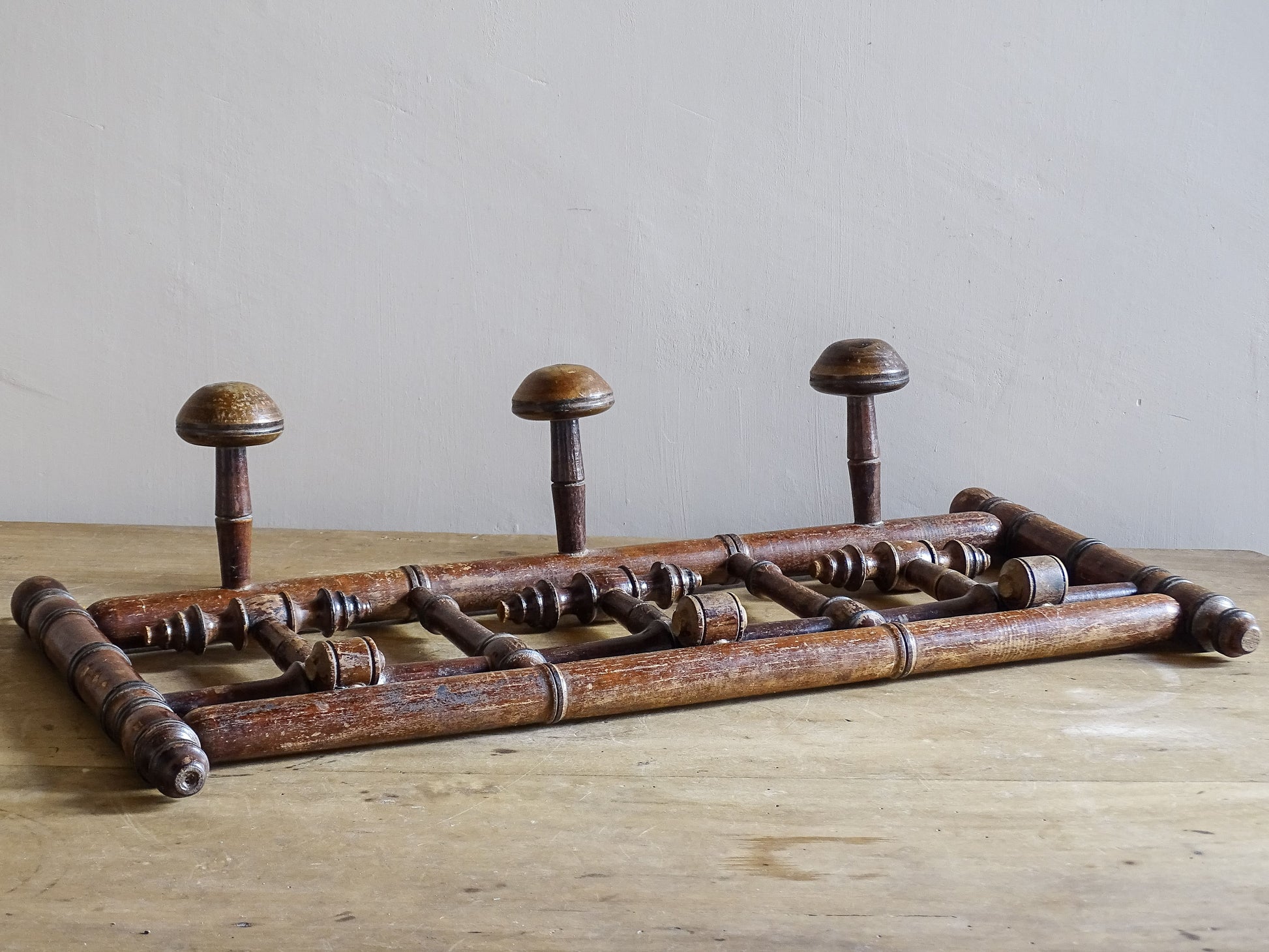 French antique faux bamboo wooden coat hook rack with turned pegs, warm patina and rustic wear. A decorative wall rack for hallway, bedroom or boot room.