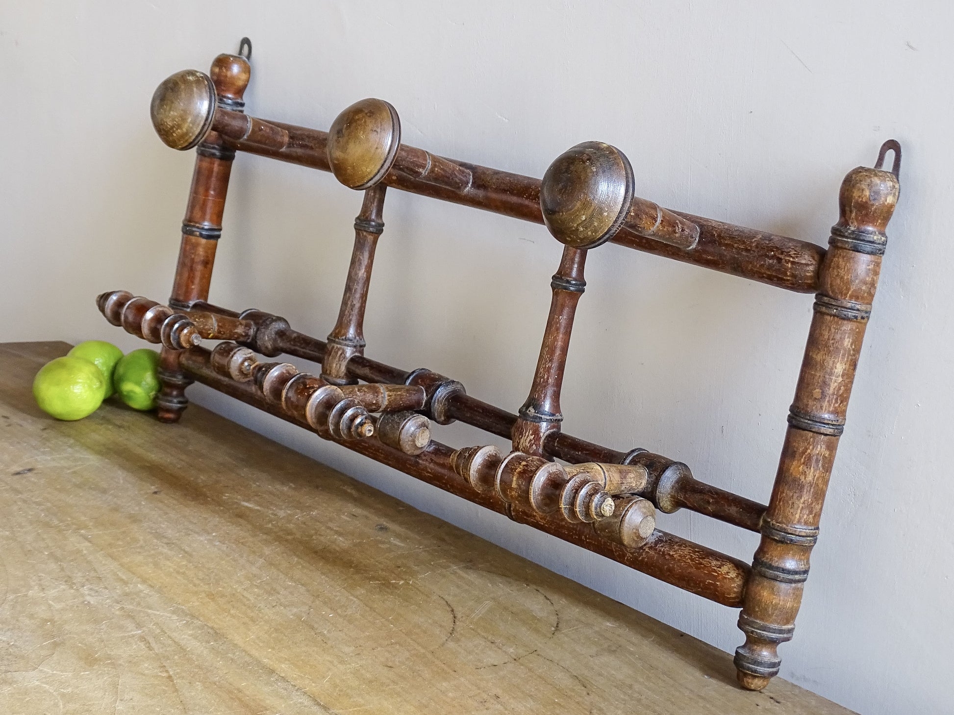 French antique faux bamboo wooden coat hook rack with turned pegs, warm patina and rustic wear. A decorative wall rack for hallway, bedroom or boot room.