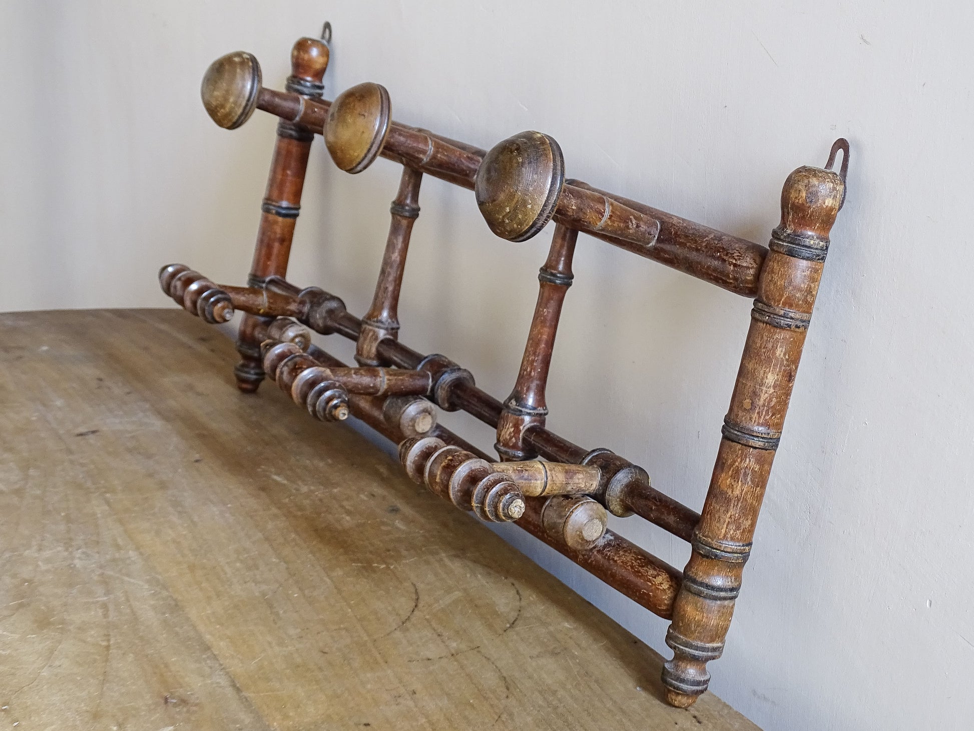 French antique faux bamboo wooden coat hook rack with turned pegs, warm patina and rustic wear. A decorative wall rack for hallway, bedroom or boot room.