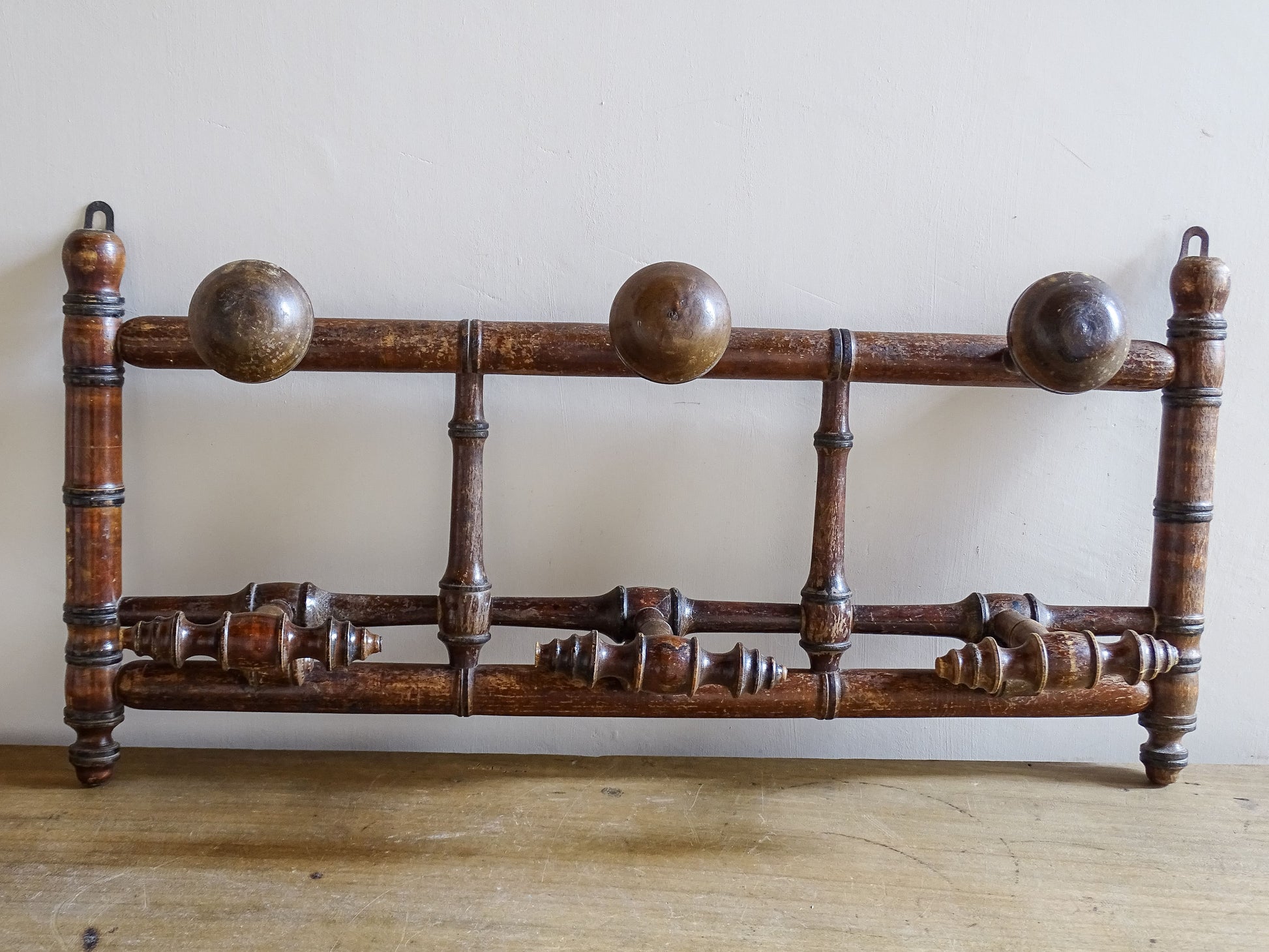 French antique faux bamboo wooden coat hook rack with turned pegs, warm patina and rustic wear. A decorative wall rack for hallway, bedroom or boot room.