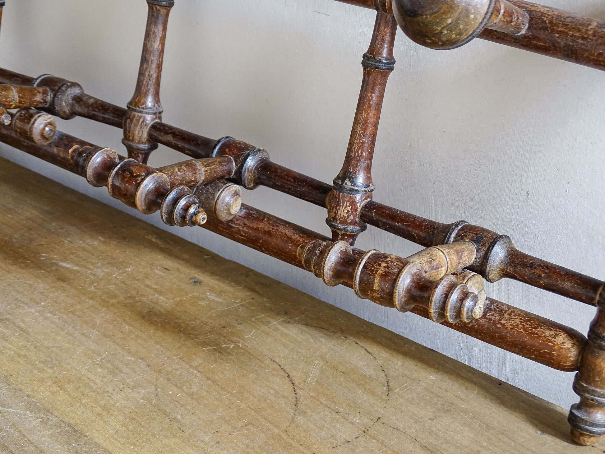 French antique faux bamboo wooden coat hook rack with turned pegs, warm patina and rustic wear. A decorative wall rack for hallway, bedroom or boot room.
