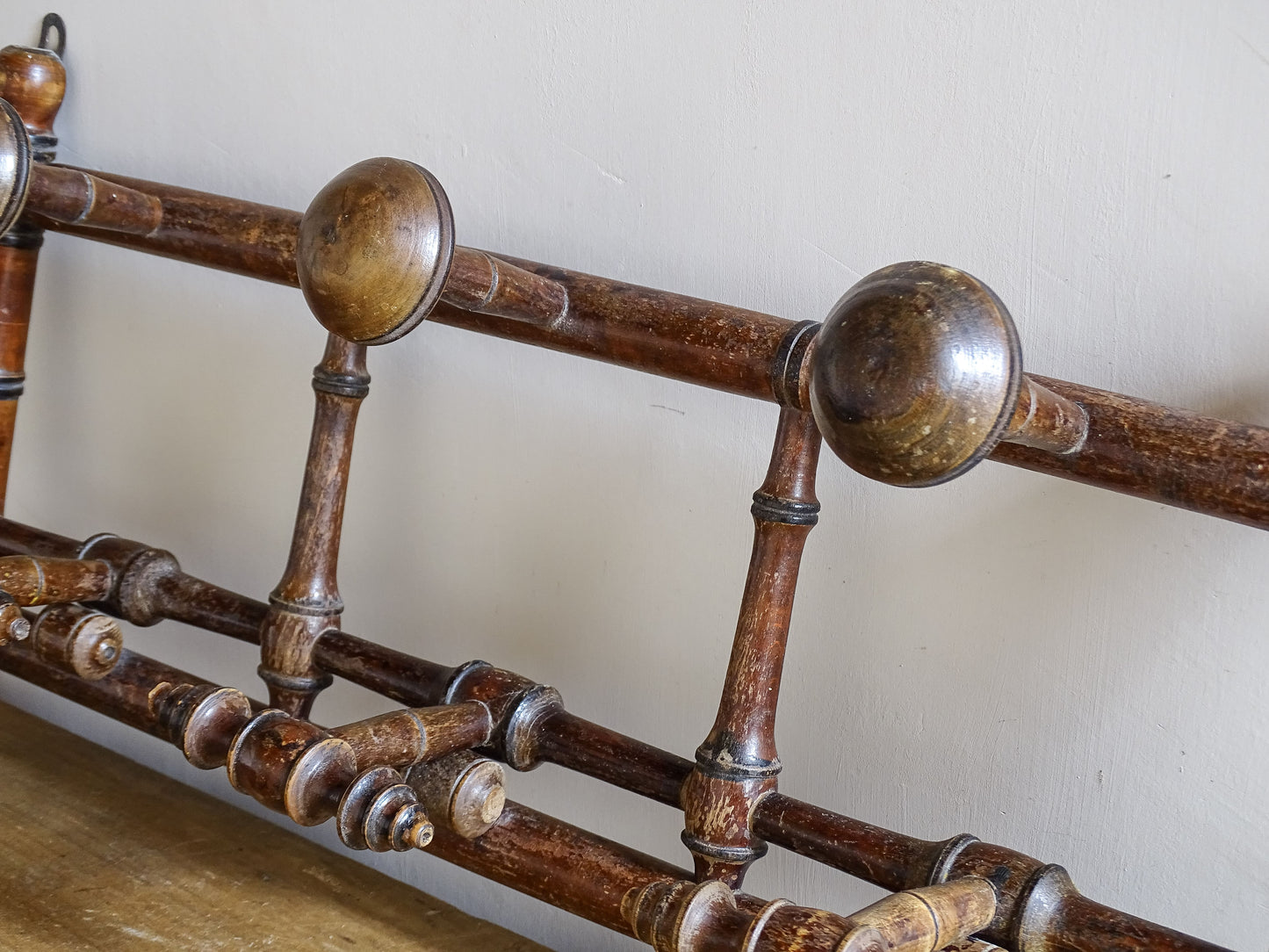 French antique faux bamboo wooden coat hook rack with turned pegs, warm patina and rustic wear. A decorative wall rack for hallway, bedroom or boot room.