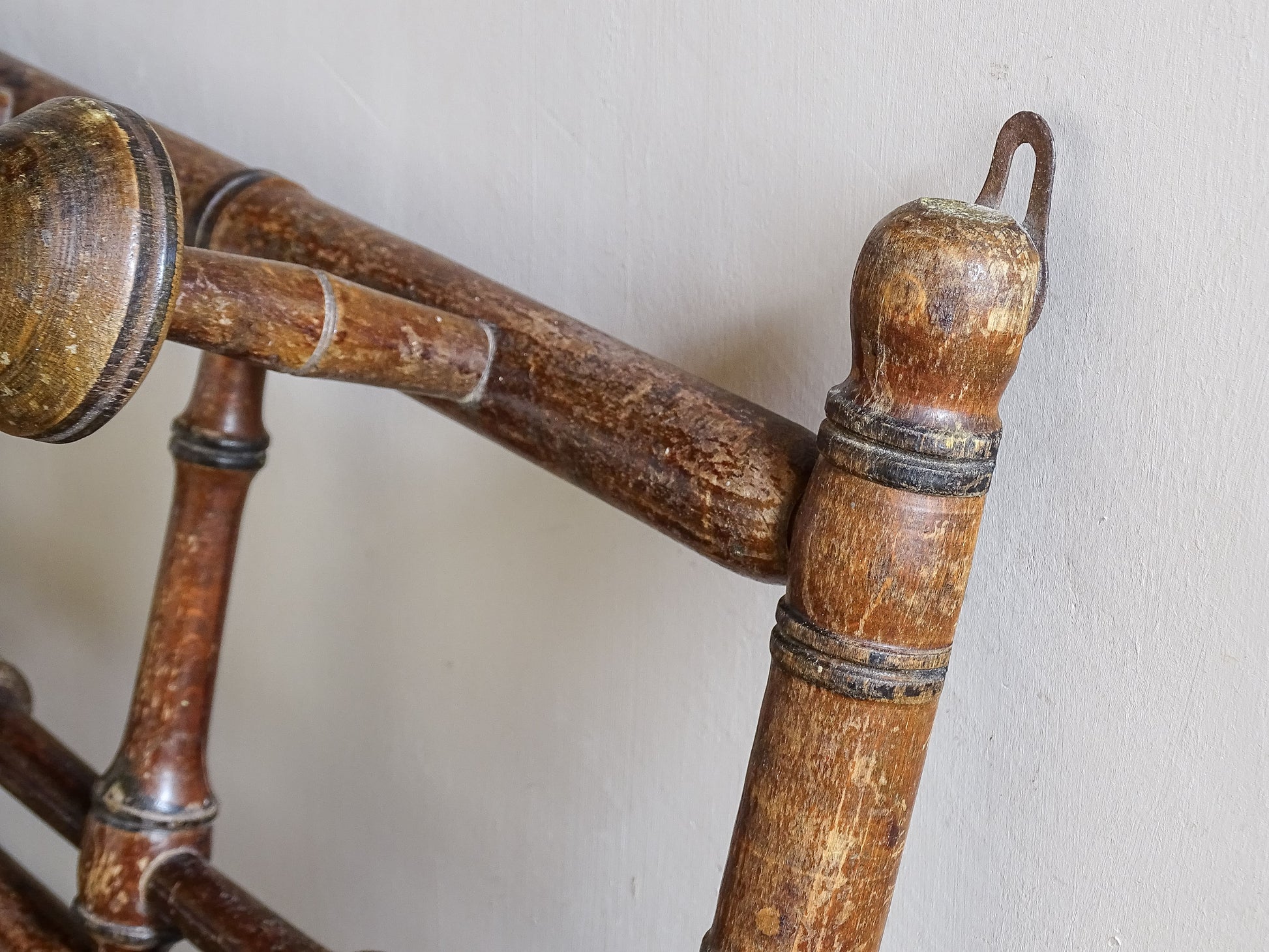 French antique faux bamboo wooden coat hook rack with turned pegs, warm patina and rustic wear. A decorative wall rack for hallway, bedroom or boot room.