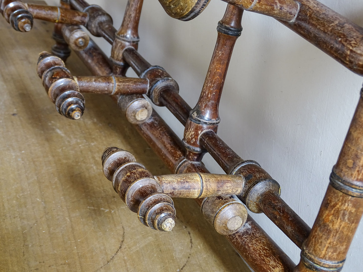 French antique faux bamboo wooden coat hook rack with turned pegs, warm patina and rustic wear. A decorative wall rack for hallway, bedroom or boot room.