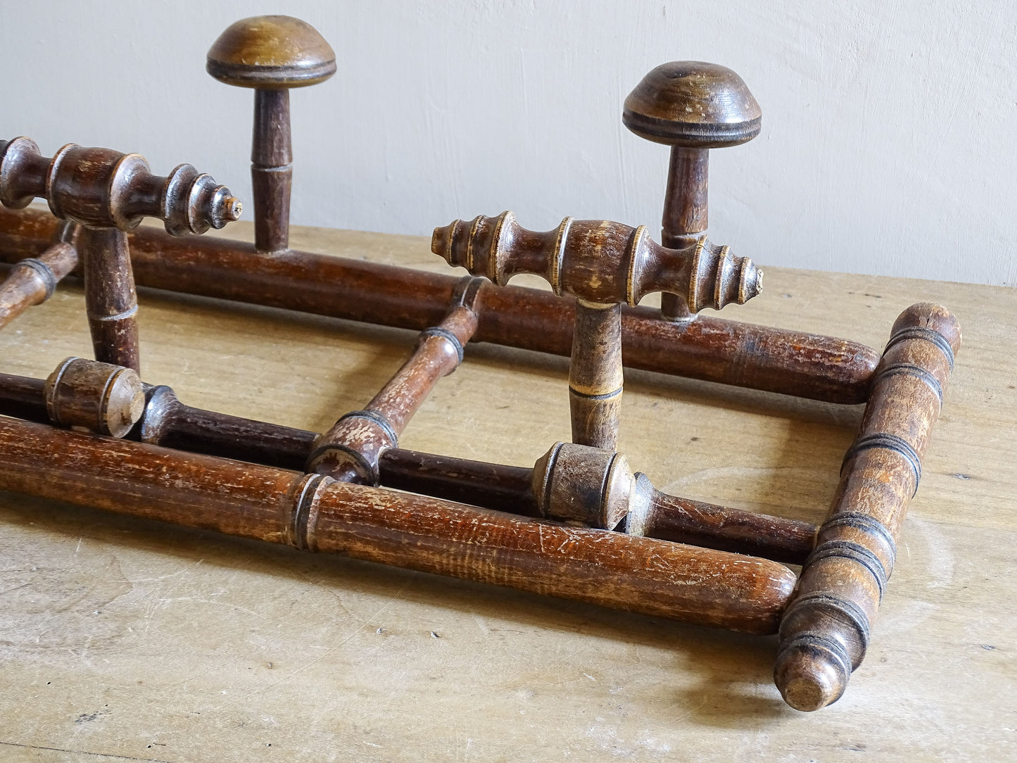 French antique faux bamboo wooden coat hook rack with turned pegs, warm patina and rustic wear. A decorative wall rack for hallway, bedroom or boot room.
