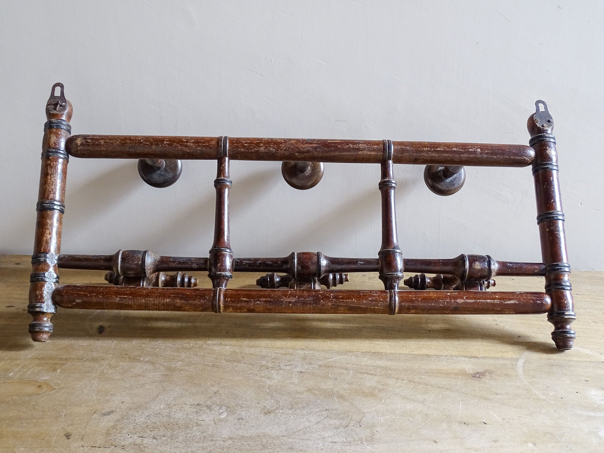 French antique faux bamboo wooden coat hook rack with turned pegs, warm patina and rustic wear. A decorative wall rack for hallway, bedroom or boot room.