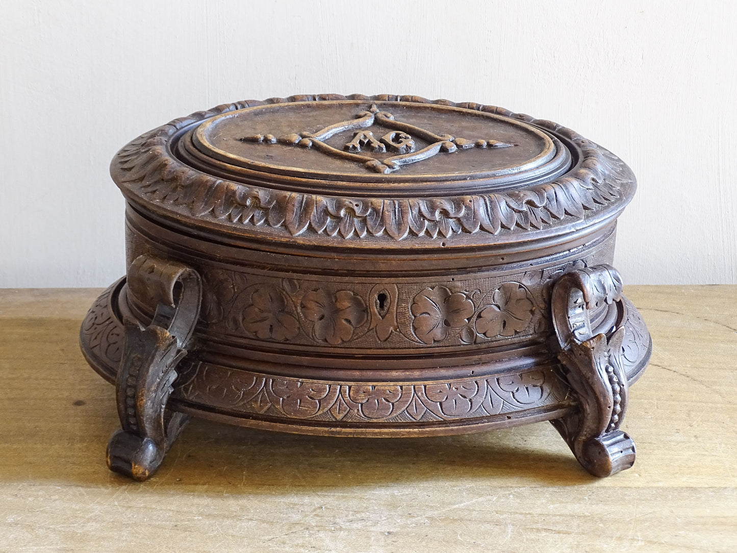 Antique monogrammed wooden casket with tufted silk interior