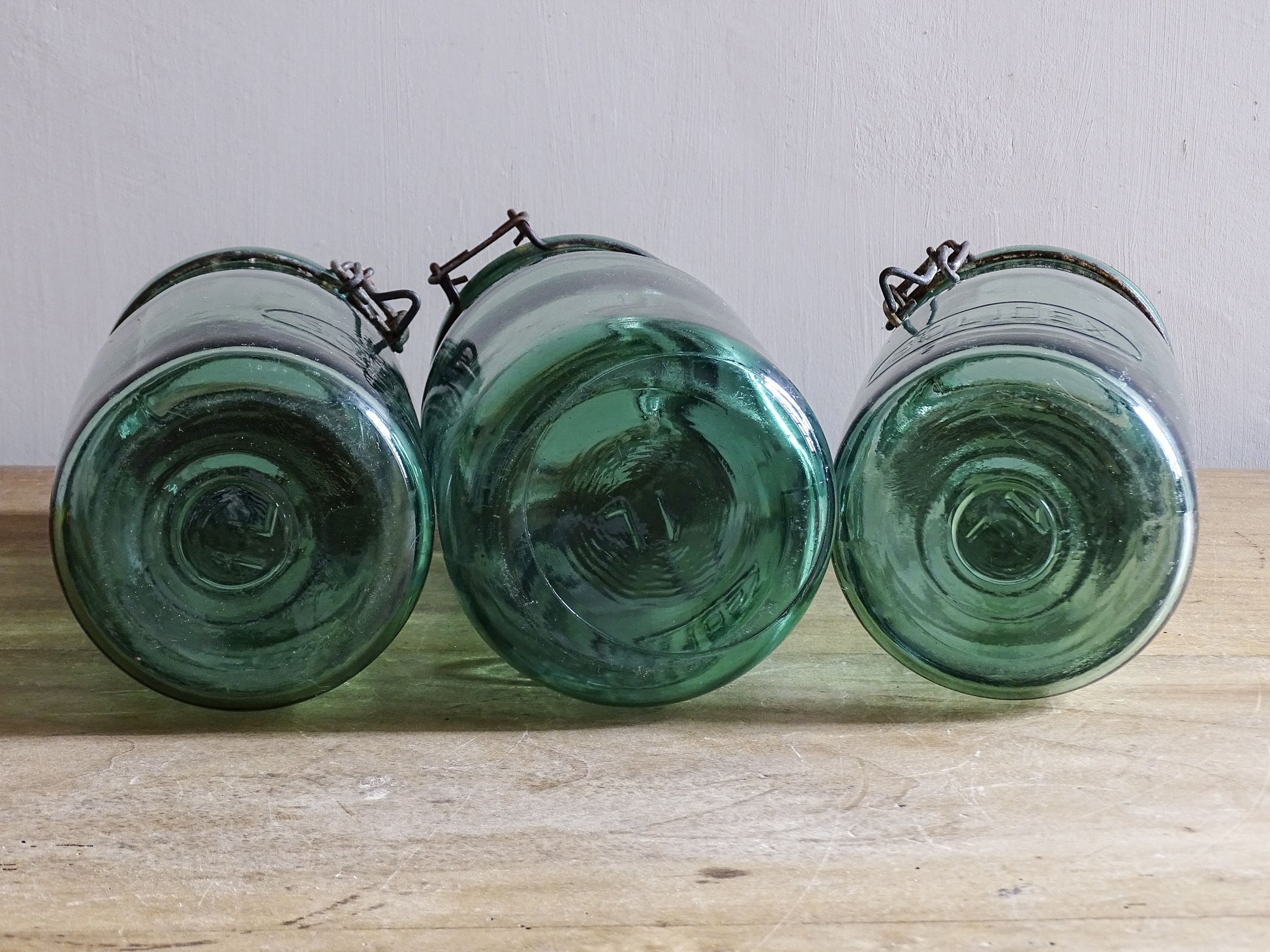 Close up of vintage French SOLIDEX glass jar lids and aged wire fastenings