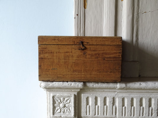 A rustic French wooden storage box pictured in a country house setting