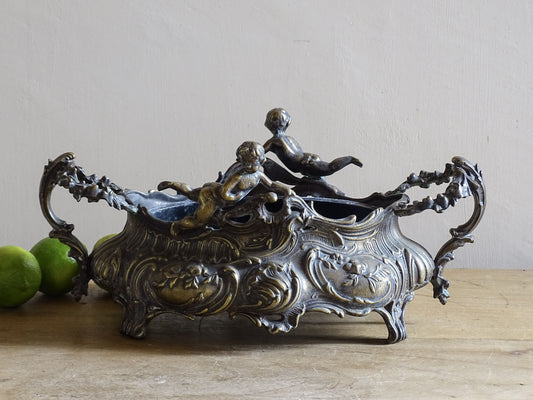 French Art Nouveau jardinière with putti figures and scrolling rococo decoration