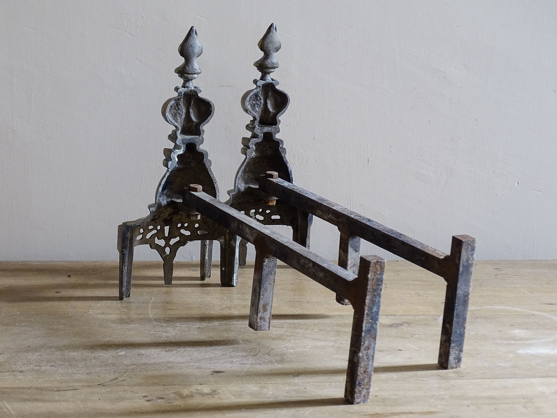 Brass and iron Gothic Revival andirons with aged patina