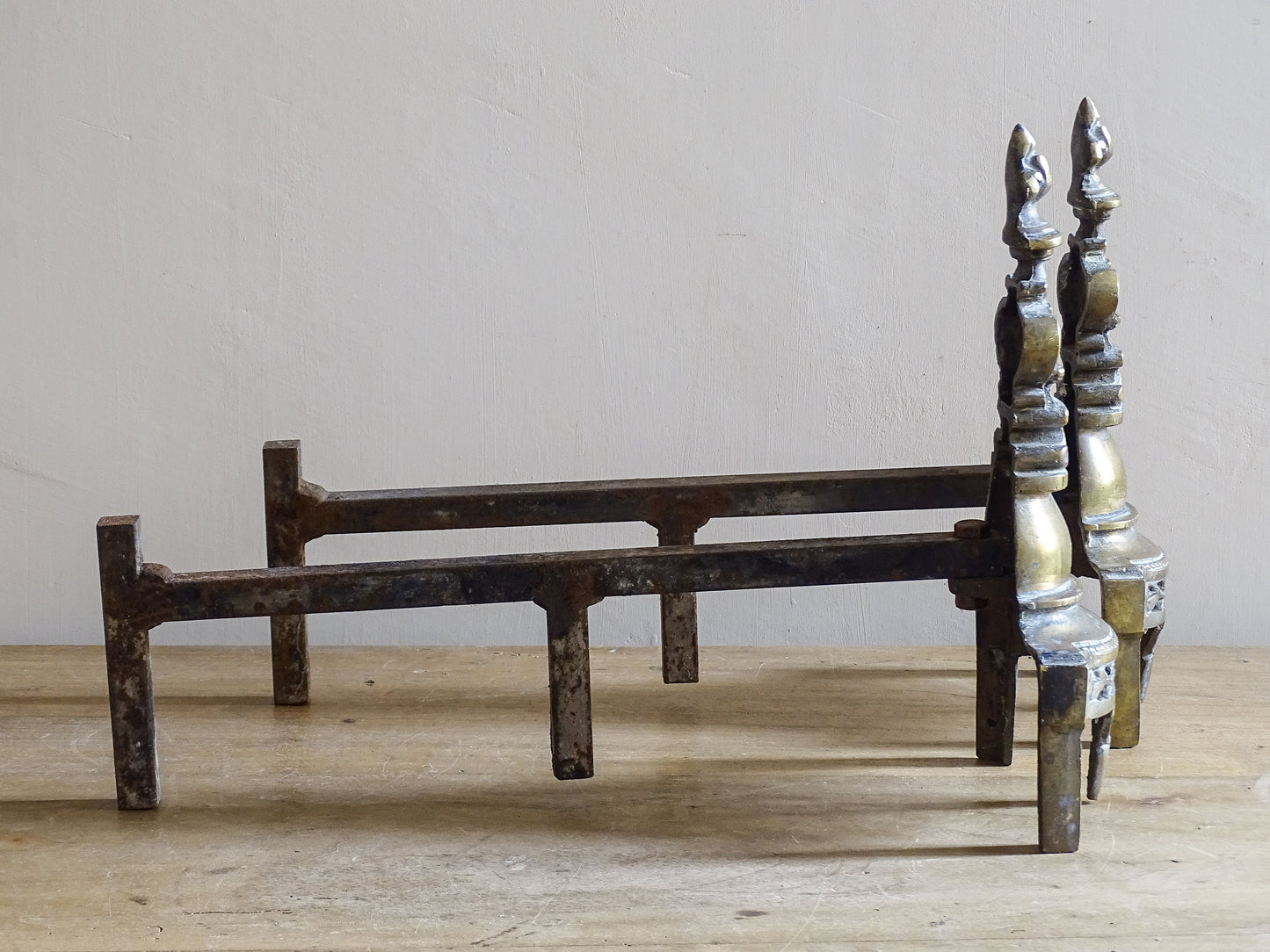 Pair of antique French fireplace firedogs with fleur de lys finials