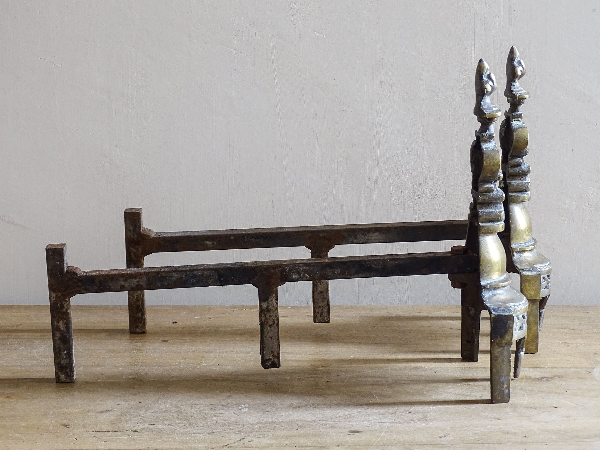 Pair of antique French fireplace firedogs with fleur de lys finials
