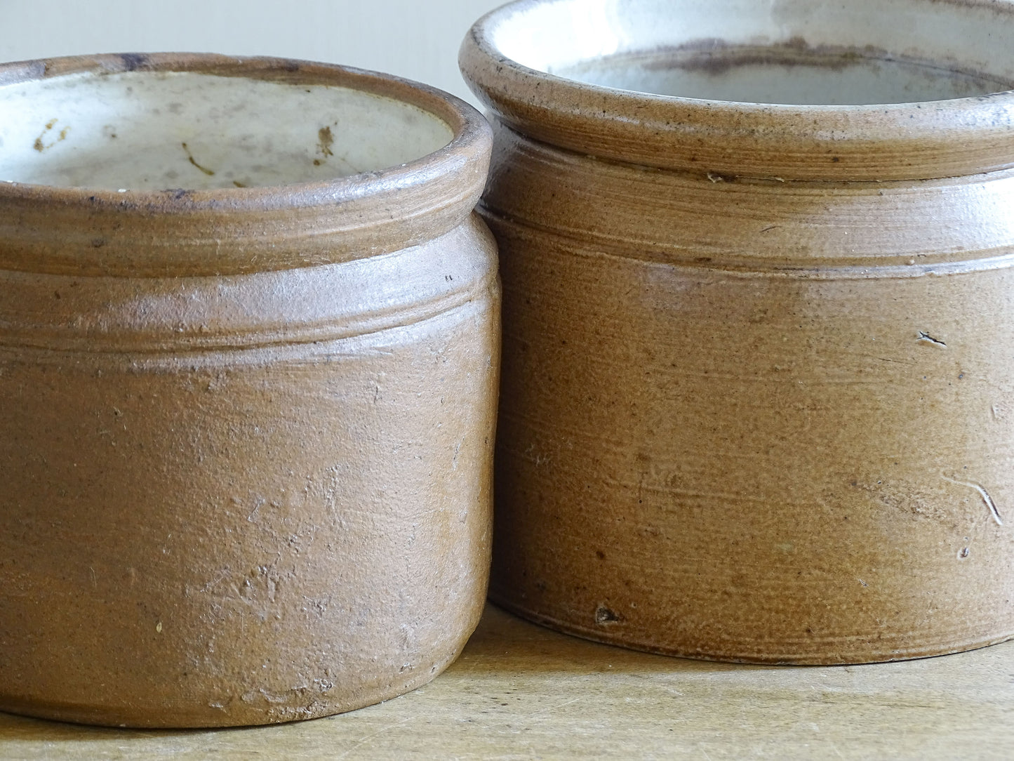 Vintage French brown stoneware mugs with pale glazed interiors and rustic finish