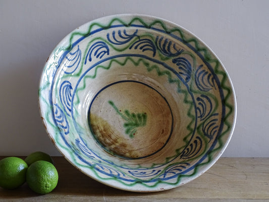 Vintage Spanish lebrillo bowl with blue and green hand-painted decoration