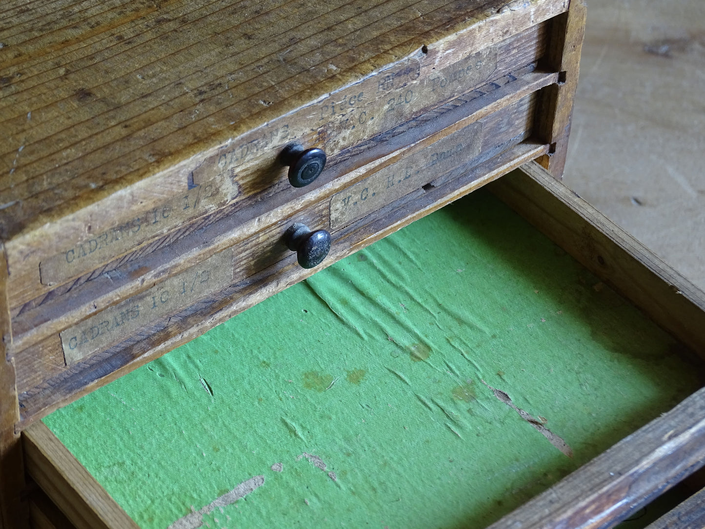 French antique storage cabinet with shallow drawers and worn workshop patina