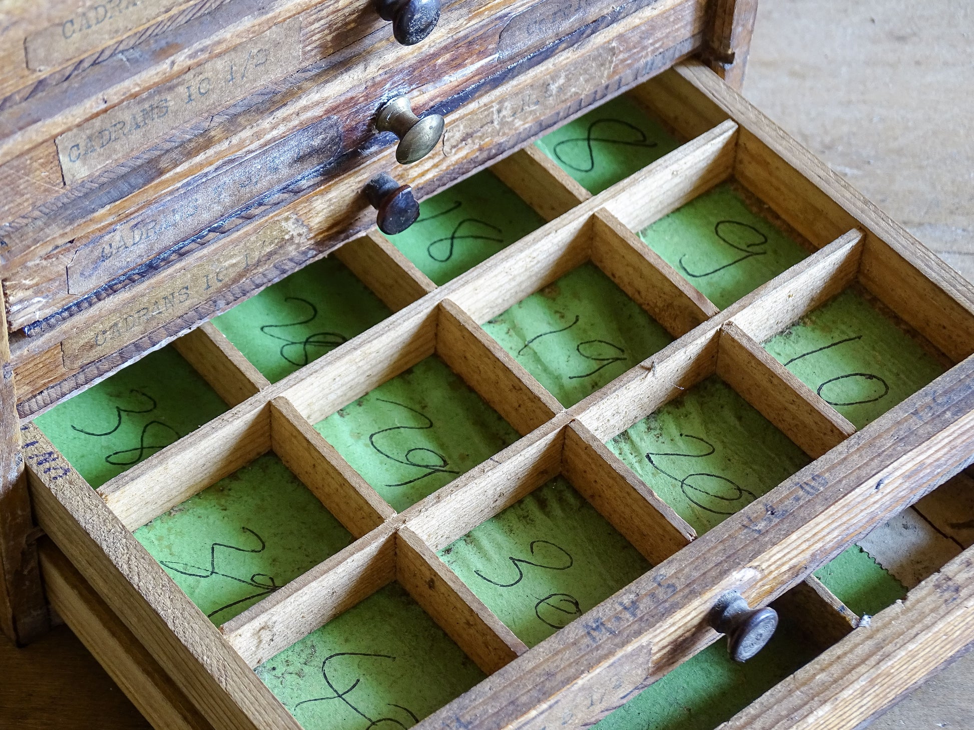 Early 20th century pine workshop cabinet with green paper lined drawers