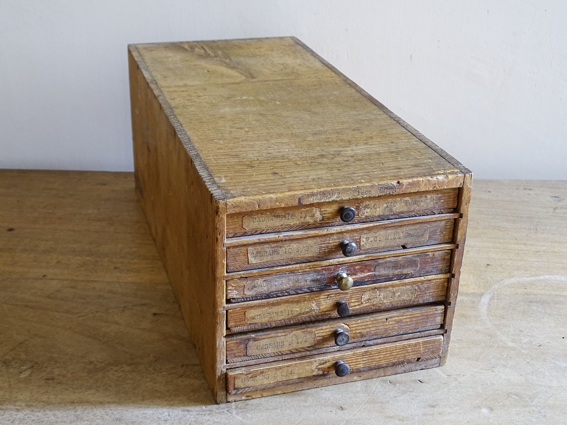 French watchmaker’s drawer cabinet with mixed wooden and brass knobs