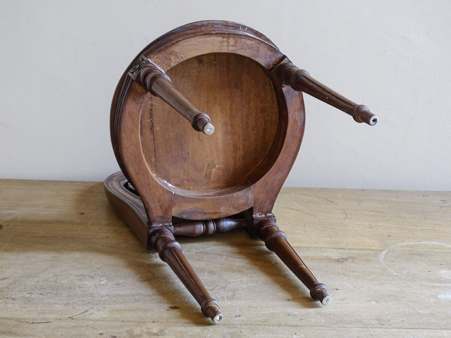 Antique miniature decorative chair photographed beside limes for scale