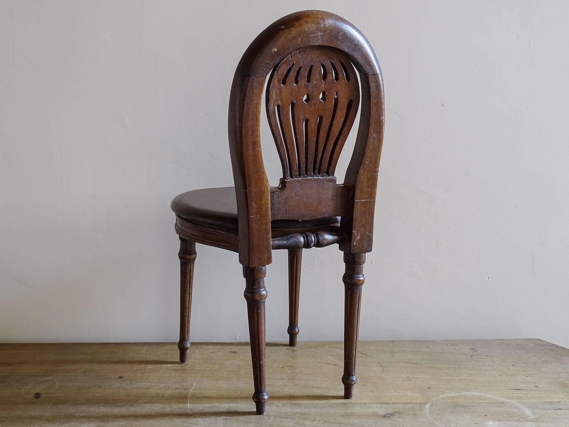 Decorative antique miniature chair in dark polished wood with floral carved details
