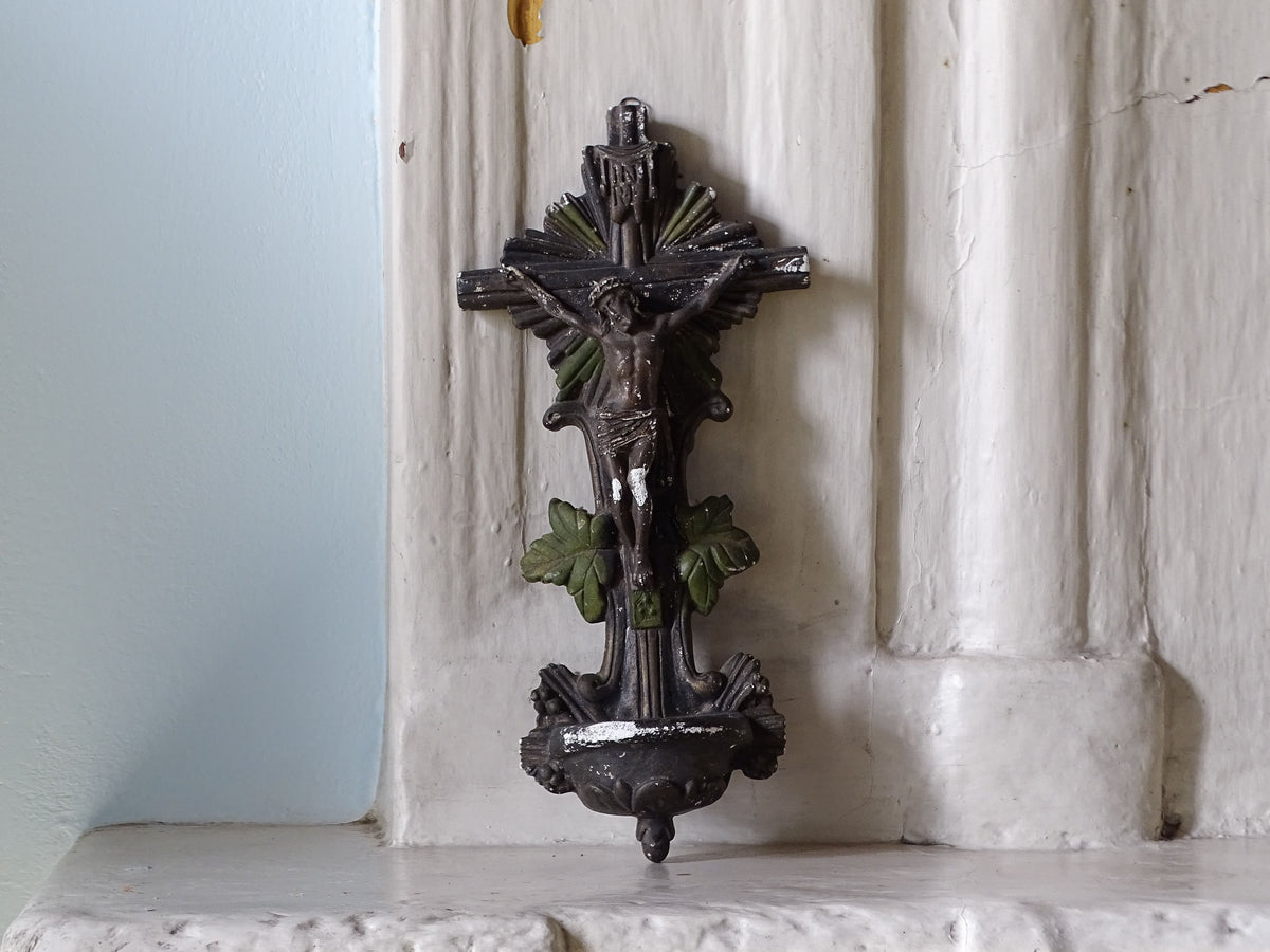 French antique holy water font crucifix in plaster, displayed on a country house fireplace