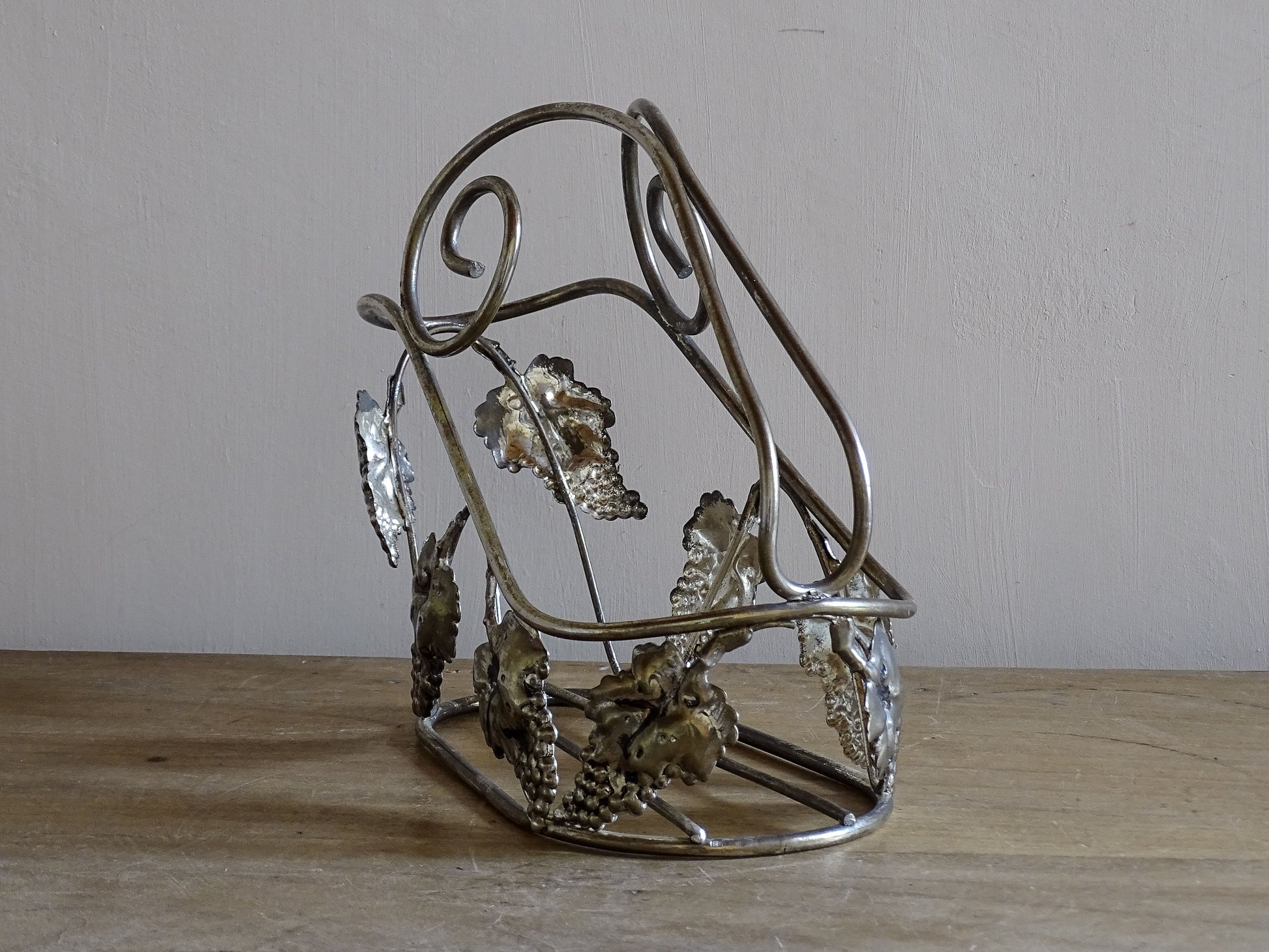 Sculptural mid-century wine bottle pourer in silvered metal with scrolling handles