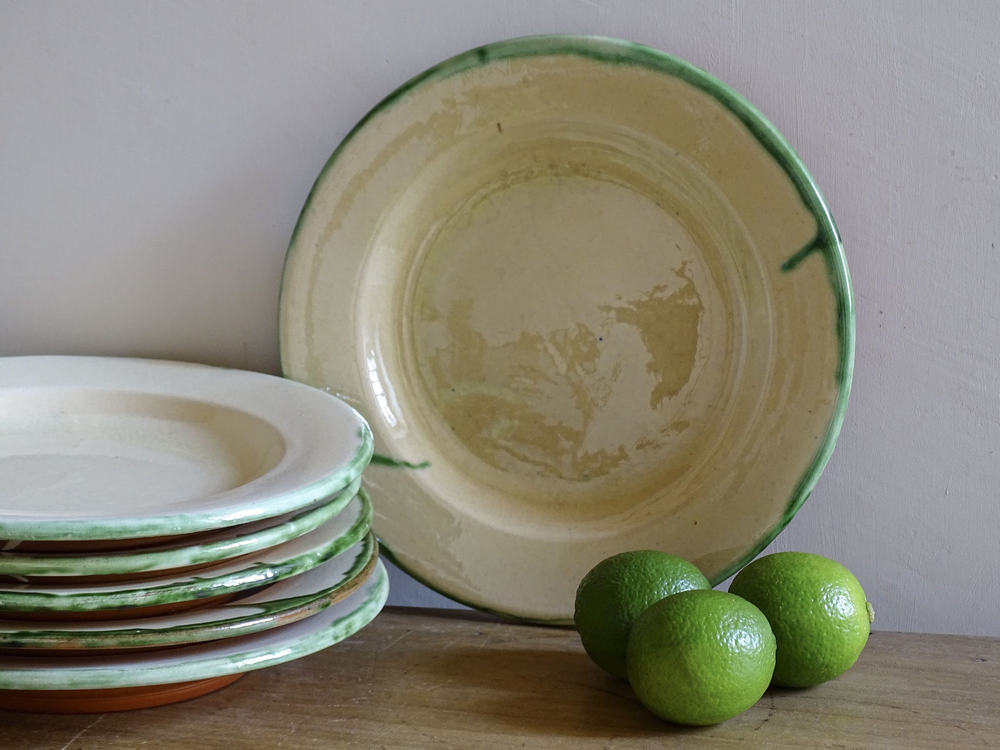 Set of six vintage French earthenware plates with green drip glaze rims
