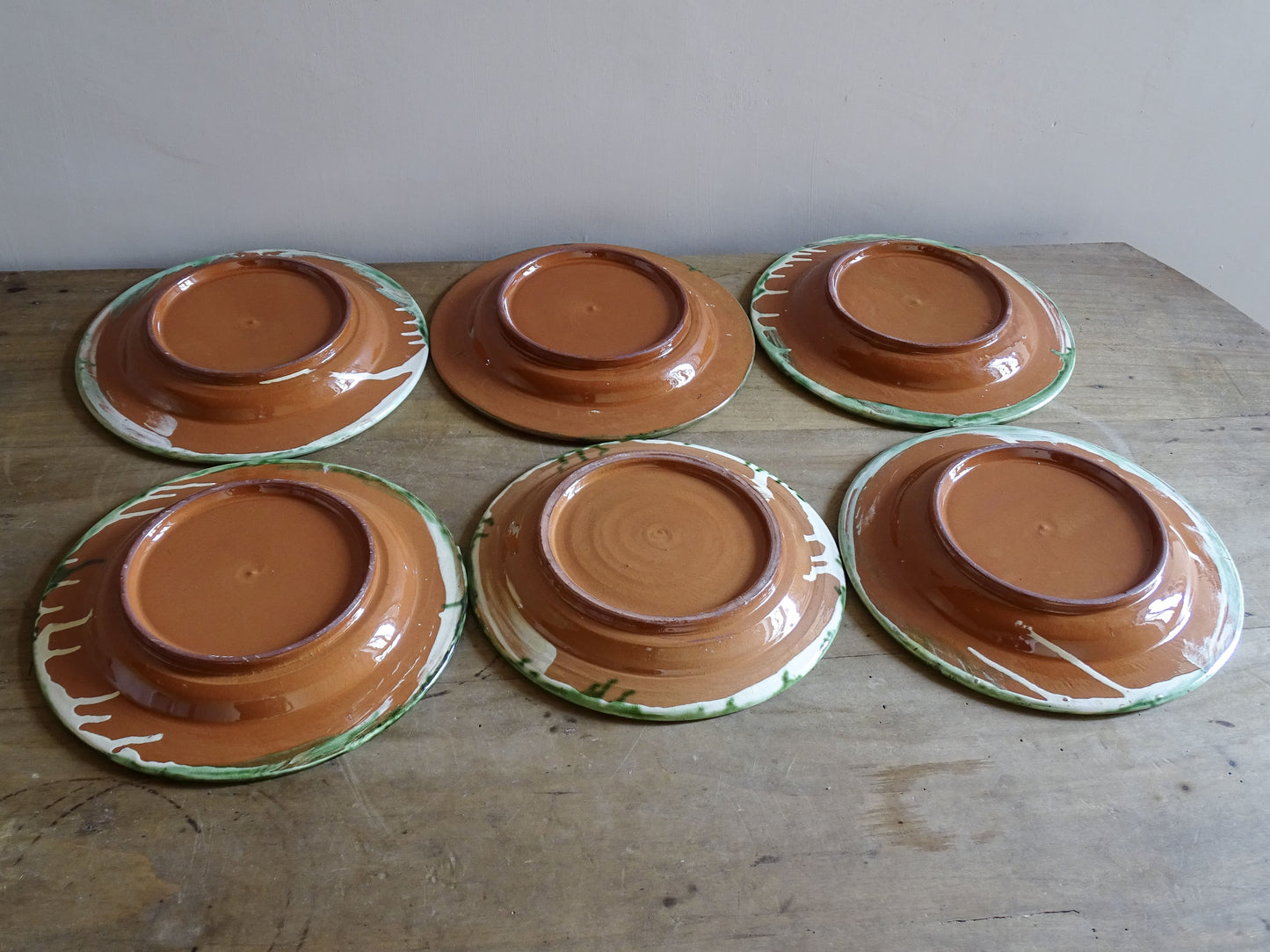 French country style earthenware plates displayed in rustic kitchen setting