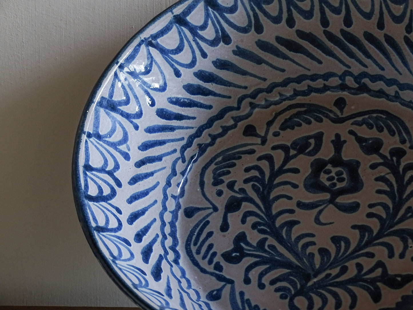 Rustic Spanish earthenware bowl with cobalt blue traditional painted pomegranate motifs