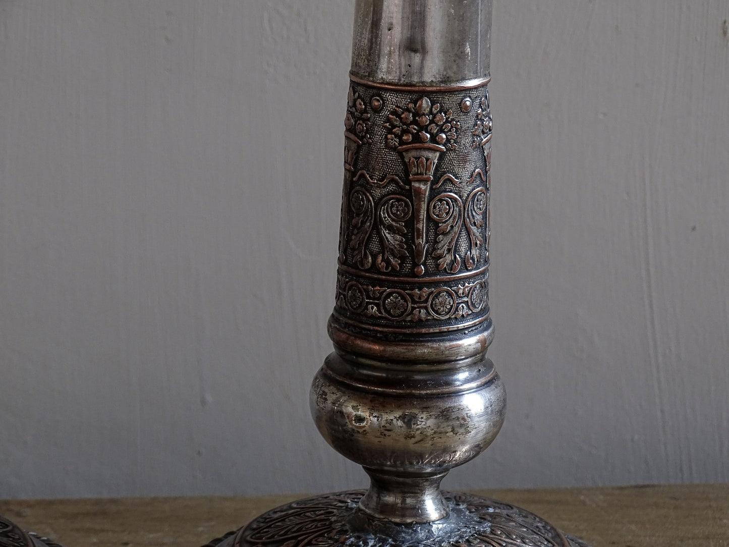Decorative French antique candlesticks with repoussé floral and scrollwork detailing