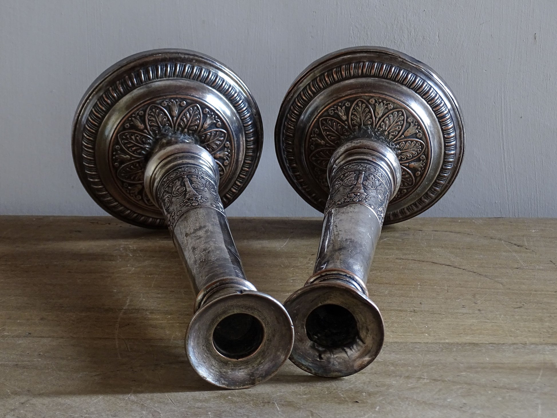 French Belle Époque silver-plated candlesticks with embossed decorative bands and heavy bases