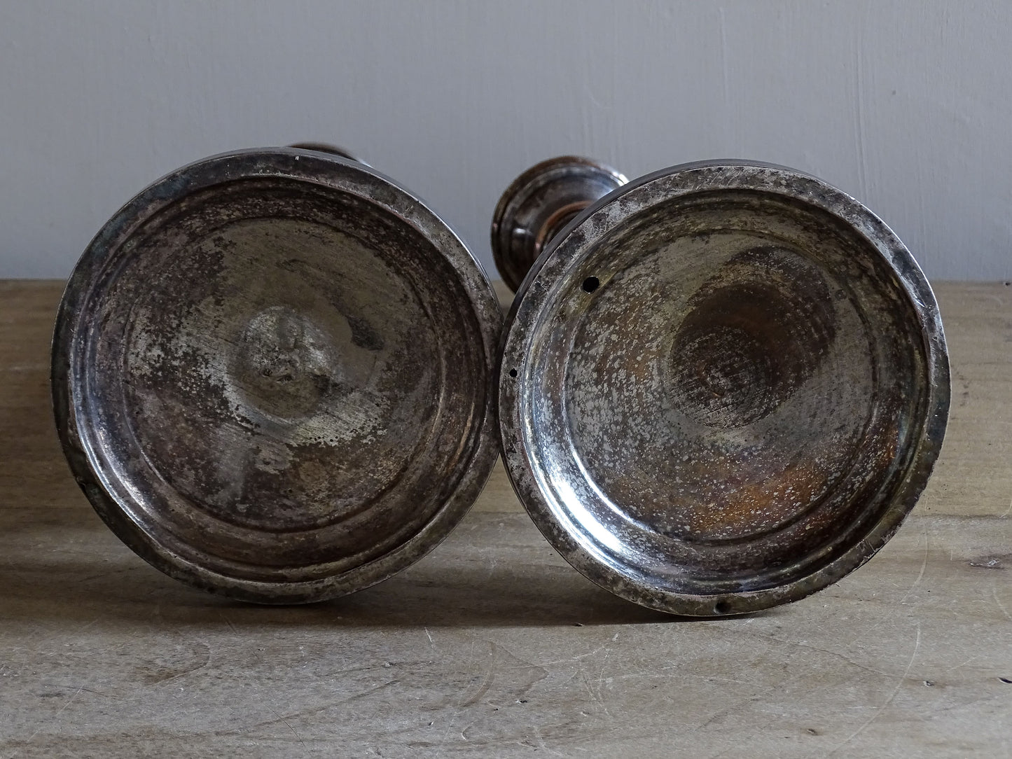 Antique silver-plated candlesticks from France with aged silver finish and decorative relief motifs
