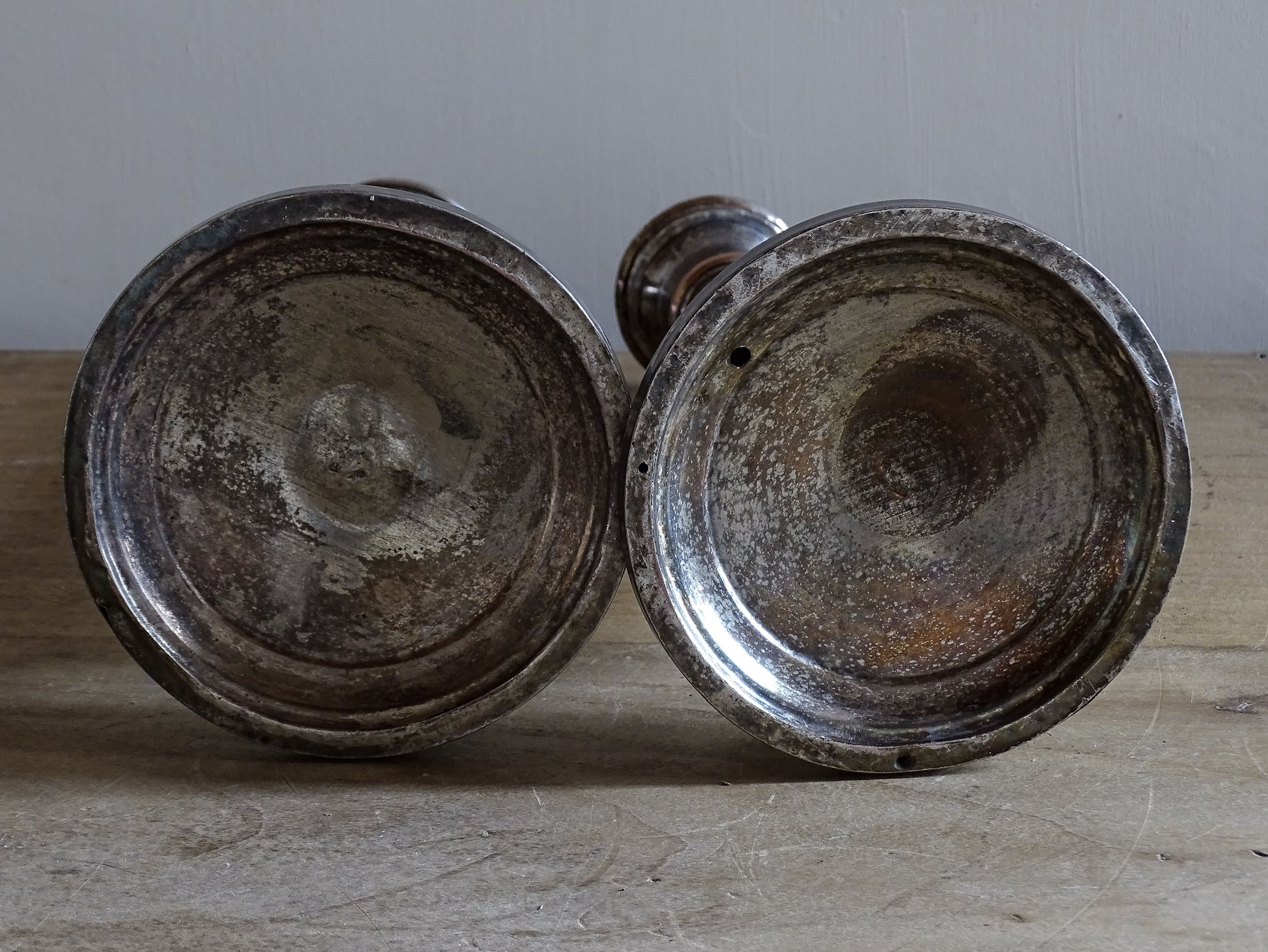 Antique silver-plated candlesticks from France with aged silver finish and decorative relief motifs
