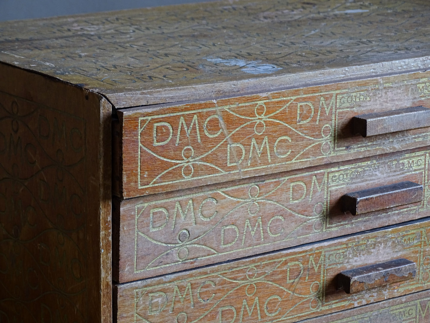 Decorative French DMC thread storage cabinet with aged wooden finish