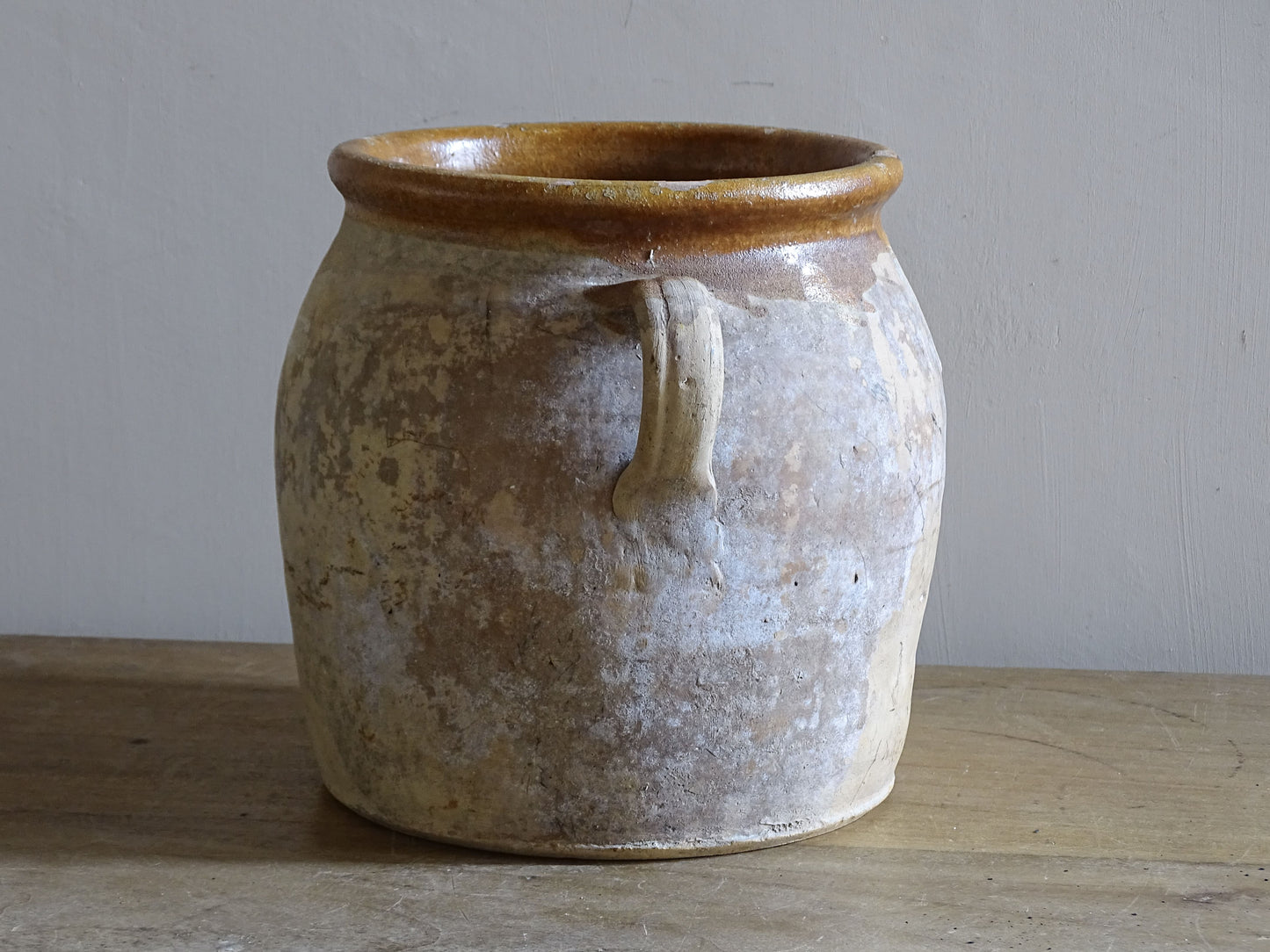 Decorative vintage French pottery pot with traditional twin handles and aged finish