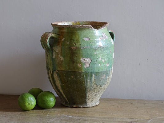 Antique French confit pot with heavily weathered green glaze and rustic earthenware surface