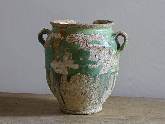 Rustic French pottery confit pot with aged green  and yellow glaze and exposed terracotta clay