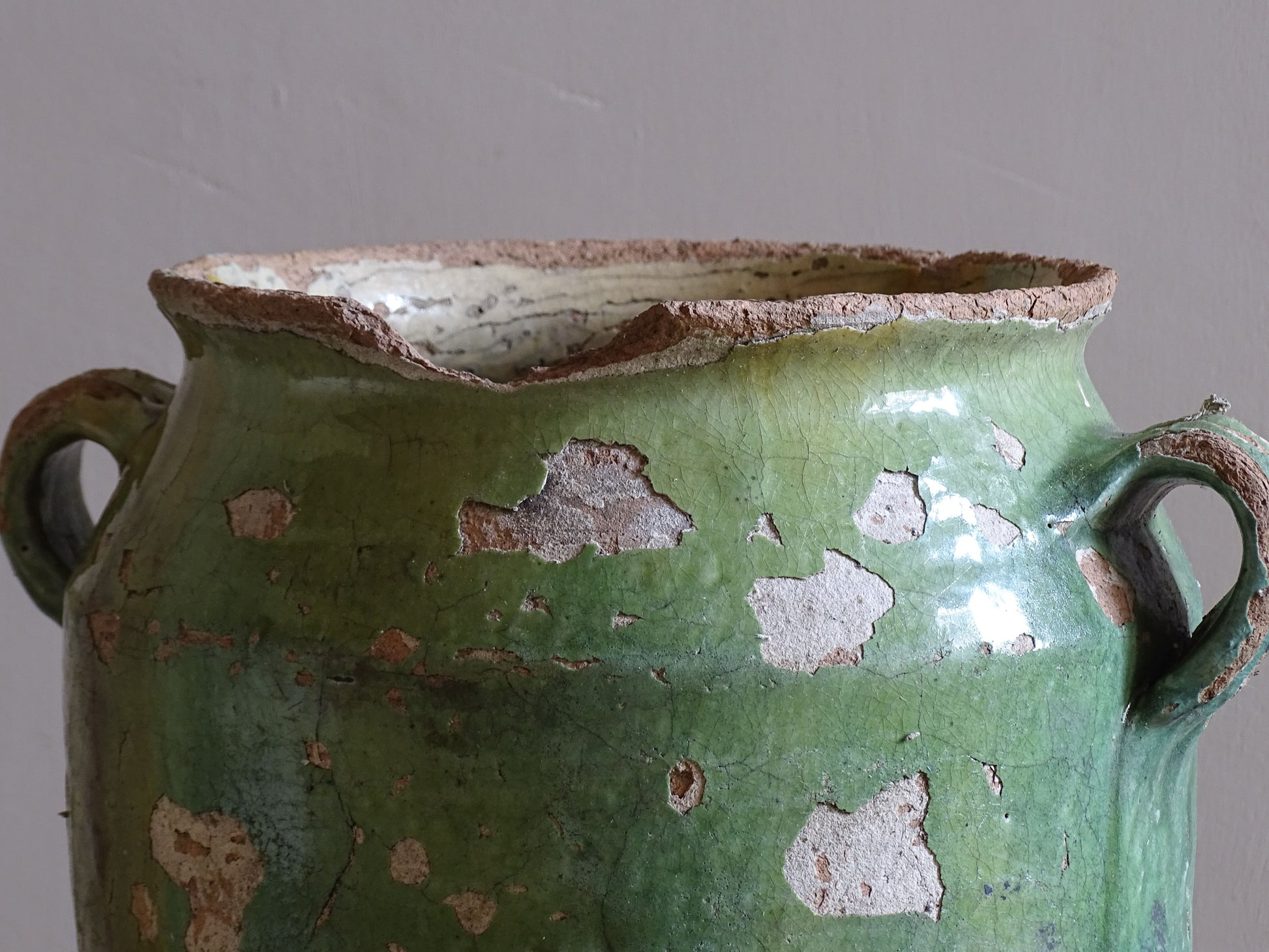 Large French confit pot with distressed green glaze and exposed earthenware body