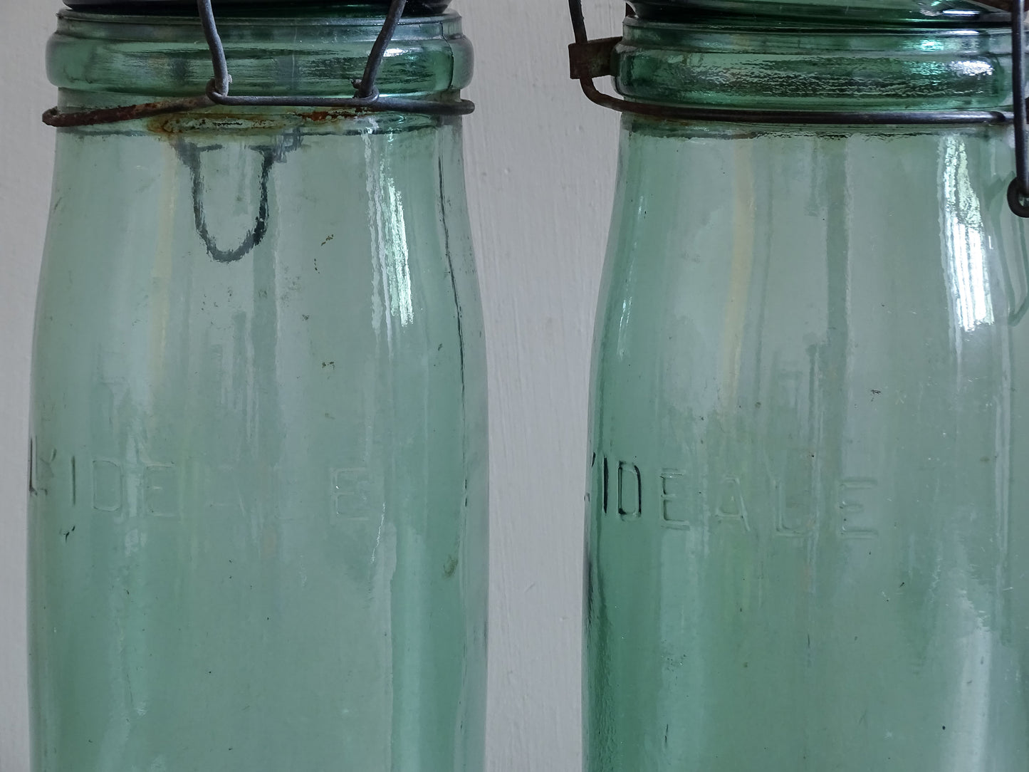 Rustic aqua glass preserving jars styled on wooden tabletop