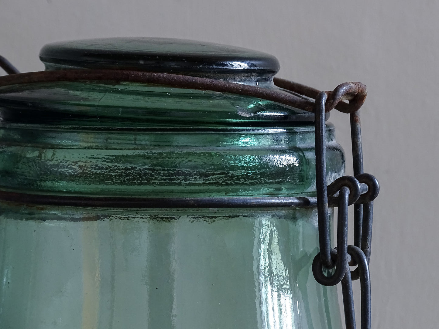 Close up of vintage French glass jar lid and wire closure detail