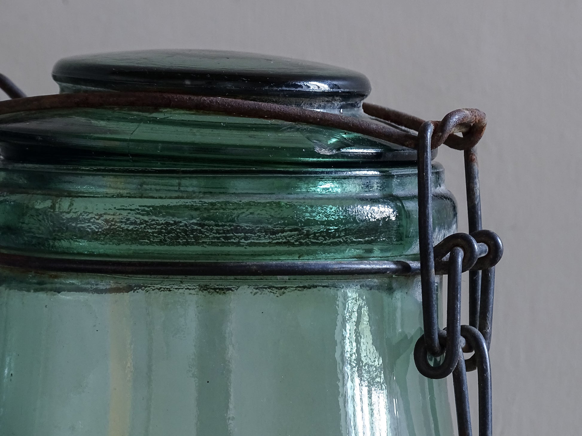 Close up of vintage French glass jar lid and wire closure detail