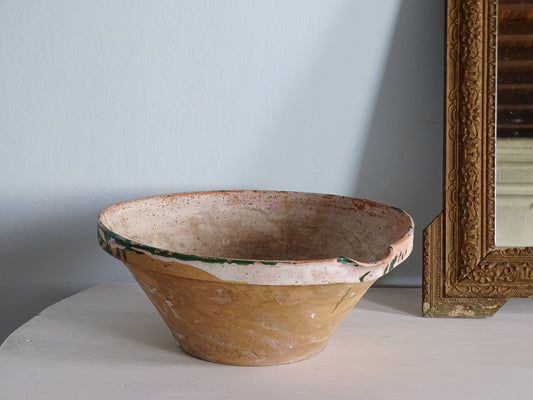 French antique tian bowl with heavily worn green glaze, pictured next to a gold frame