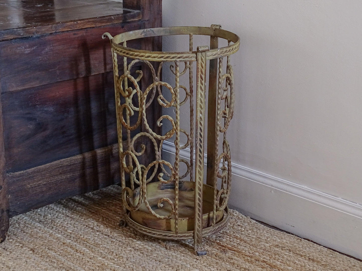 French vintage metal umbrella stand with decorative scrollwork and removable drip tray