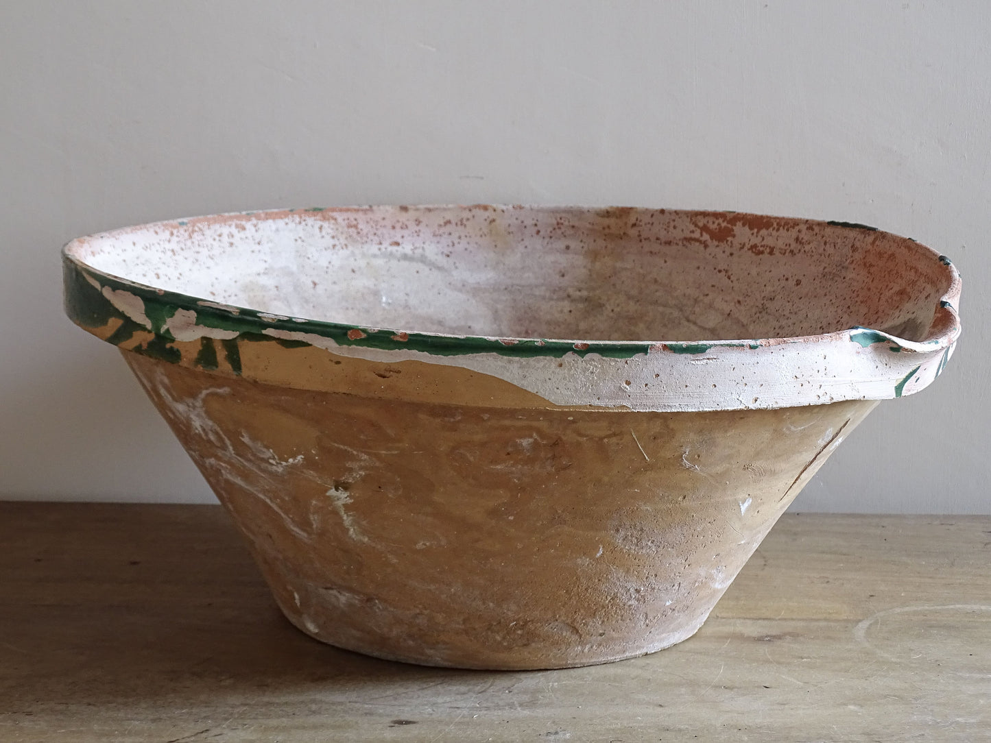 Large rustic French pottery tian bowl on wooden farmhouse table