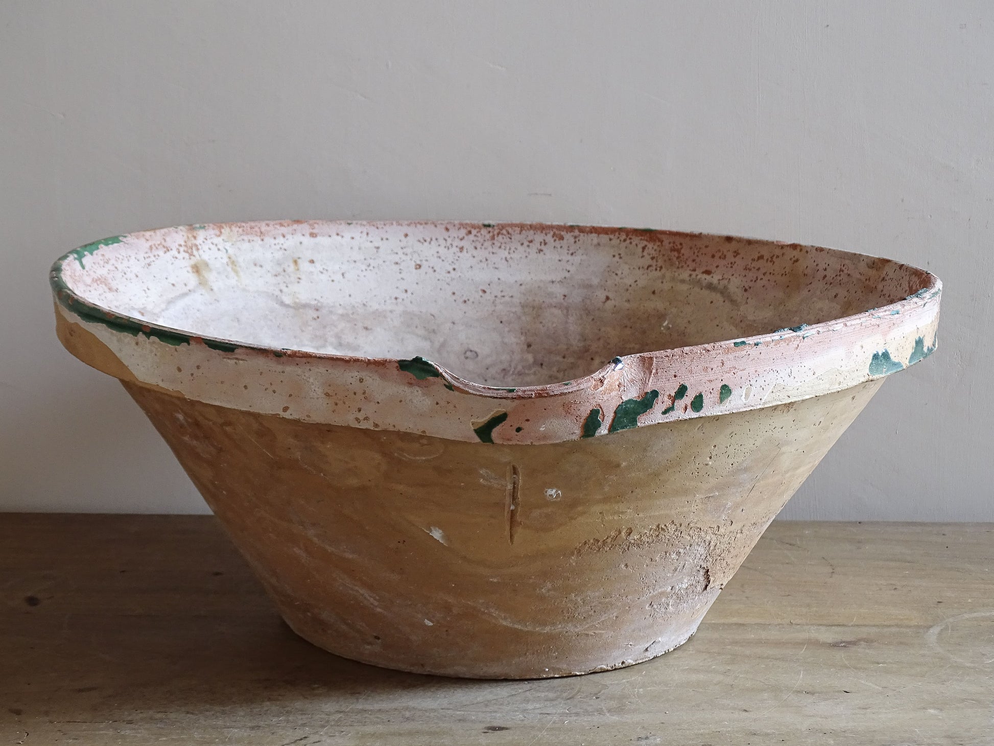 Antique French country kitchen bowl with heavily worn green glaze