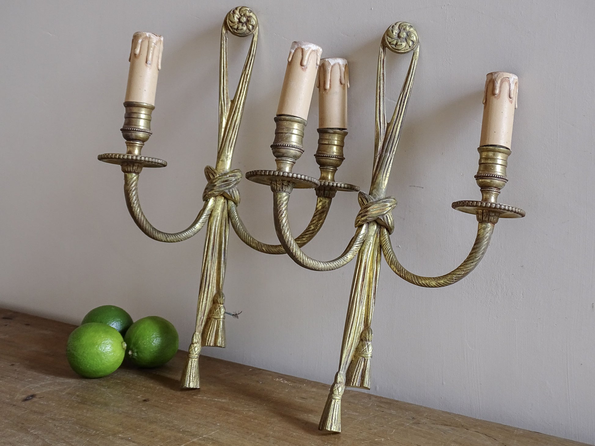 Pair of French vintage gilt metal wall sconces with tassel detail