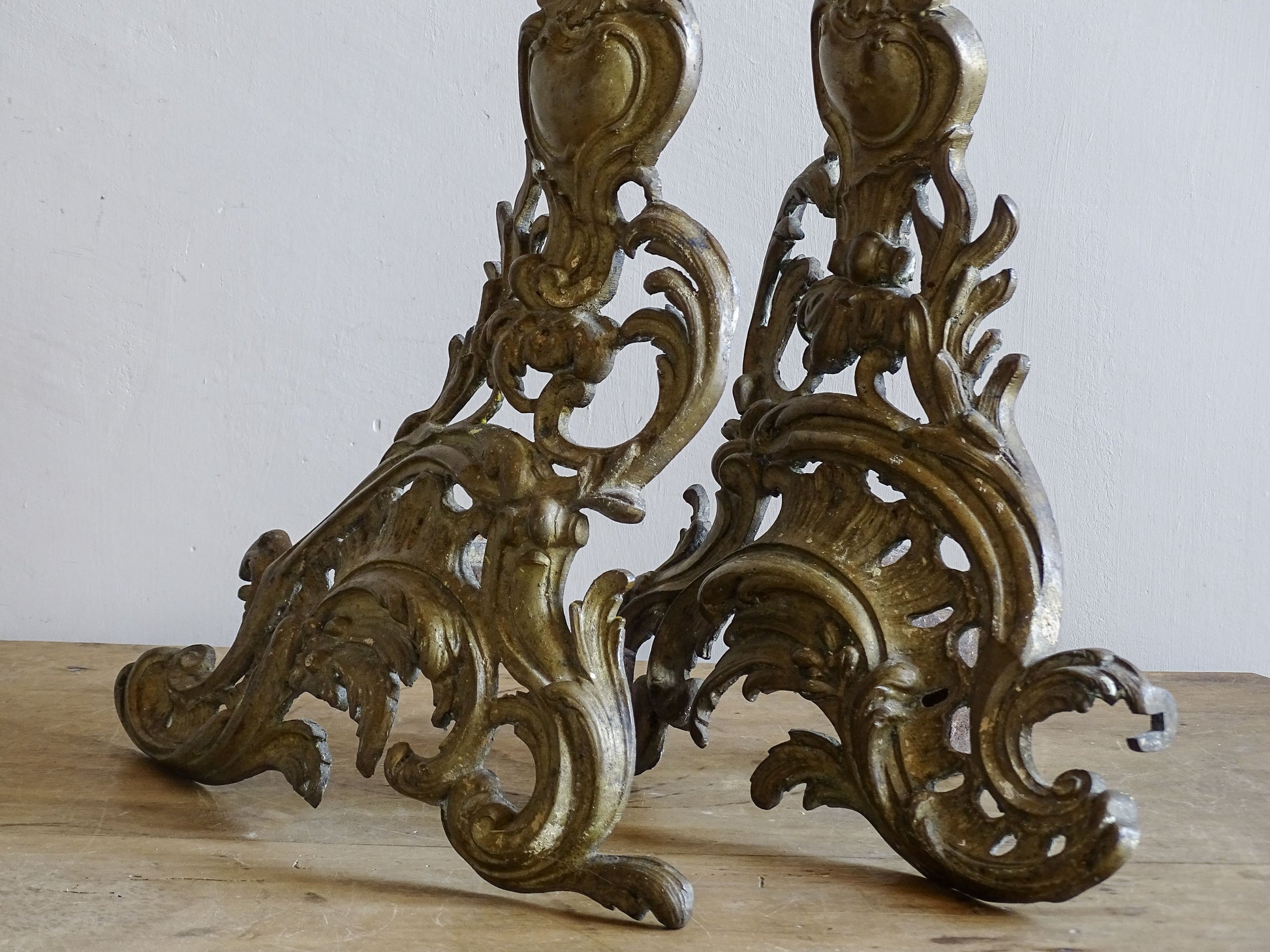 Ornate pair of French brass andirons with pierced foliate scrollwork