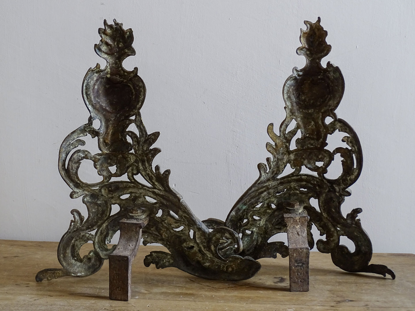 Pair of decorative antique andirons with rocaille and shell ornament